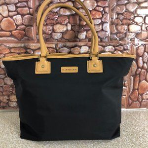 Hartmann black nylon tote hand bag with tan brown leather trim .